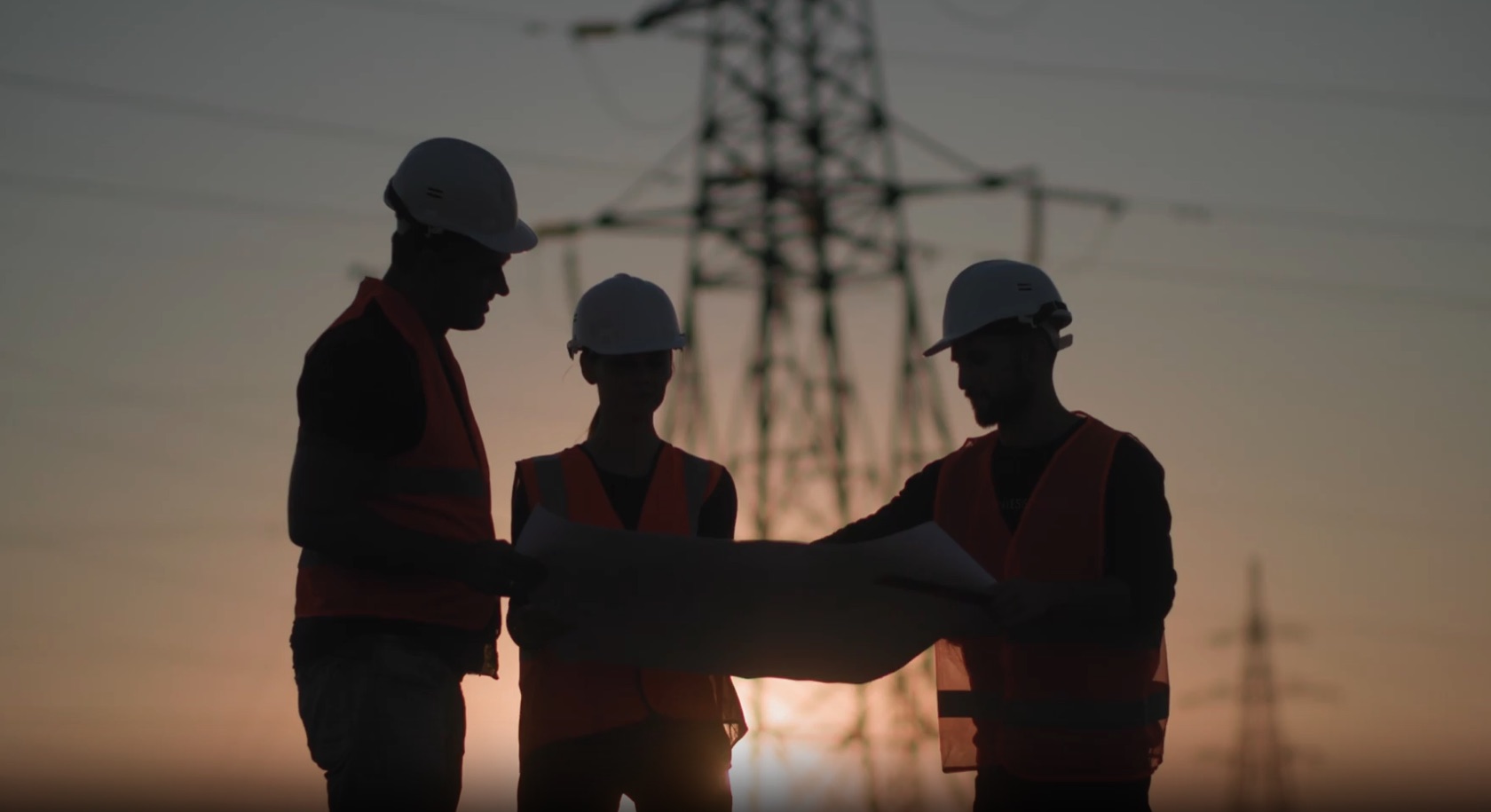 Ambition engineers reviewing site plans at sunset